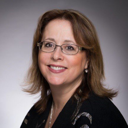 A woman with glasses wearing a black shirt